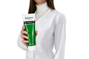 Healthcare professional holding an ALHYDRAN cream tube, showing the base formula used in Anti Itch cream for eczema.